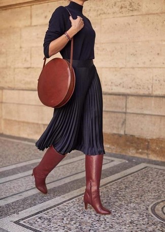 Brown Leather Watch Outfits For Women: The pairing of a black turtleneck and a brown leather watch makes for a cool off-duty look. Elevate this look with tobacco leather knee high boots.