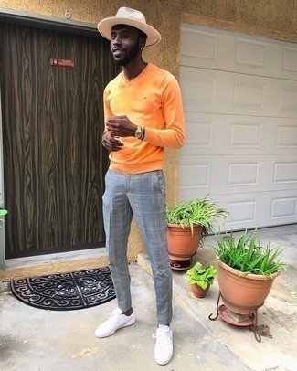 Light Blue Chinos Outfits: Rock an orange v-neck sweater with light blue chinos to demonstrate you've got serious styling prowess. To bring a sense of stylish effortlessness to your getup, add white canvas low top sneakers to the mix.