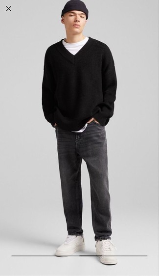 Black V-neck Sweater Outfits For Men: A black v-neck sweater and charcoal jeans have become true closet items for most gentlemen. Our favorite of a variety of ways to complement this getup is a pair of white leather low top sneakers.