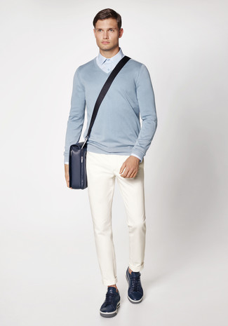 Navy Leather Messenger Bag Outfits: If you gravitate towards relaxed dressing, why not try this combination of a light blue v-neck sweater and a navy leather messenger bag? Rev up the dressiness of this ensemble a bit by slipping into navy leather low top sneakers.