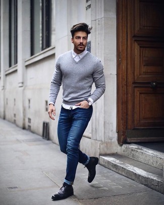 White Dress Shirt with Navy Jeans Smart Casual Outfits For Men: For a casually stylish look, consider wearing a white dress shirt and navy jeans — these two items go beautifully together. Unimpressed with this ensemble? Enter black leather chelsea boots to mix things up a bit.