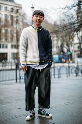 Blue Vertical Striped Chinos Outfits: Putting together a navy and white v-neck sweater with blue vertical striped chinos is an on-point choice for a casual yet sharp ensemble. Kick up your outfit with black print canvas high top sneakers.