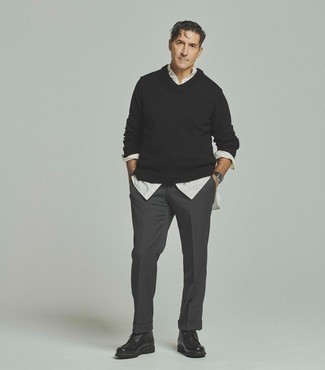 Charcoal Dress Pants Outfits For Men: Team a black v-neck sweater with charcoal dress pants for a stylish and refined look. Rev up this ensemble with black leather casual boots.