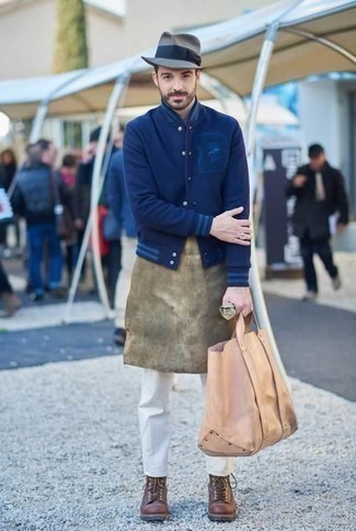 Beige Leather Tote Bag Outfits For Men: Such staples as a navy varsity jacket and a beige leather tote bag are an easy way to introduce effortless cool into your daily styling rotation. For maximum style, complete your outfit with brown leather casual boots.