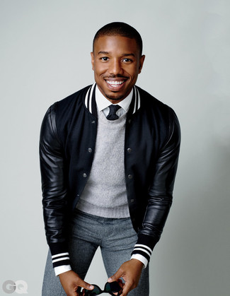 Black and White Varsity Jacket Outfits For Men: For an effortlessly sleek look, dress in a black and white varsity jacket and grey wool dress pants — these pieces fit pretty good together.