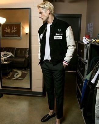 Black and White Varsity Jacket Outfits For Men: Go for a pared down yet casually stylish choice in a black and white varsity jacket and dark green chinos. To add some extra flair to this outfit, complete your ensemble with black leather loafers.