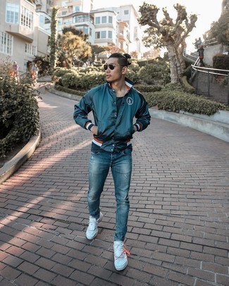 Dark Green Varsity Jacket Outfits For Men: This combination of a dark green varsity jacket and blue ripped jeans combines comfort and utility and helps keep it low profile yet modern. A pair of white athletic shoes completes this look very nicely.
