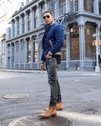 Navy Varsity Jacket Outfits For Men: Such staples as a navy varsity jacket and charcoal ripped jeans are the perfect way to introduce some cool into your current wardrobe. For something more on the classy side to finish this getup, add tan suede chelsea boots to this outfit.
