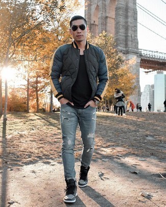 Charcoal High Top Sneakers Outfits For Men: We all seek functionality when it comes to styling, and this city casual combo of a black varsity jacket and light blue ripped jeans is a practical illustration of that. Complete this look with charcoal high top sneakers and ta-da: your look is complete.