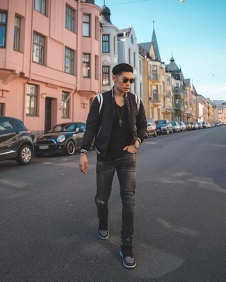 Black and White Varsity Jacket Outfits For Men: A black and white varsity jacket and charcoal ripped jeans are essential in any man's functional casual sartorial arsenal. Now all you need is a pair of black leather high top sneakers.