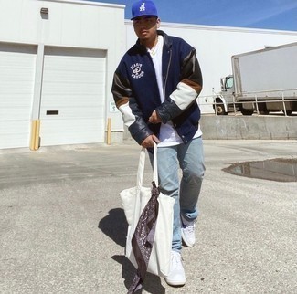 Men's Navy Varsity Jacket, White Crew-neck T-shirt, Light Blue Jeans, White and Navy Canvas Low Top Sneakers