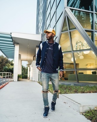 Navy Leather High Top Sneakers Outfits For Men: Choose a navy and white varsity jacket and light blue ripped jeans to assemble a casual and practical look. On the footwear front, this ensemble is rounded off really well with navy leather high top sneakers.