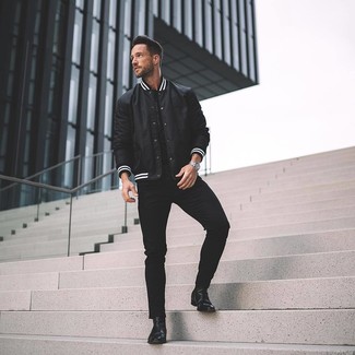 Black and White Varsity Jacket Outfits For Men: Consider teaming a black and white varsity jacket with black skinny jeans for a relaxed outfit. For something more on the smart side to finish this getup, complement your look with black leather chelsea boots.