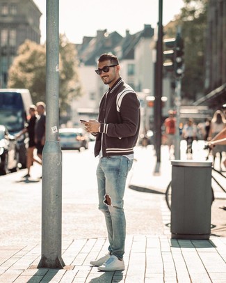 Black and White Varsity Jacket Outfits For Men: For off-duty style without the need to sacrifice on comfort, we like this combination of a black and white varsity jacket and light blue ripped skinny jeans. And if you want to immediately rev up your ensemble with one single item, why not complement this outfit with white leather low top sneakers?