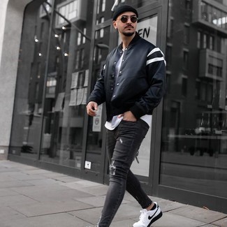 Grey Ripped Jeans Outfits For Men: If you're after a city casual and at the same time sharp look, opt for a black varsity jacket and grey ripped jeans. If you want to effortlessly up the ante of this outfit with shoes, why not complement your outfit with a pair of white and black canvas low top sneakers?