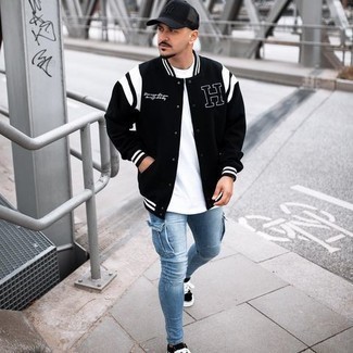 Black and White Varsity Jacket Outfits For Men: A black and white varsity jacket and light blue skinny jeans are a casual combination that every modern gent should have in his casual sartorial collection. To add some extra flair to this ensemble, introduce a pair of black and white canvas low top sneakers to the mix.