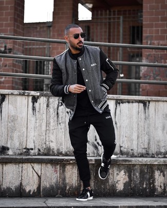 Varsity Jacket Casual Outfits For Men: Demonstrate that nobody does off-duty like you in a varsity jacket and black sweatpants. Go ahead and complete your getup with a pair of black and white leather low top sneakers for an extra touch of style.