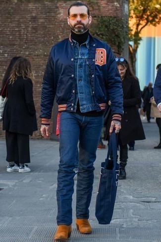Blue Denim Jacket Outfits For Men: This off-duty combination of a blue denim jacket and navy jeans is ideal if you want to go about your day with confidence in your getup. Rounding off with tobacco suede chelsea boots is a surefire way to bring a little depth to this look.