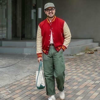 Varsity Jacket Outfits For Men: This casual combo of a varsity jacket and olive chinos is very easy to throw together without a second thought, helping you look awesome and ready for anything without spending a ton of time rummaging through your closet. Let your sartorial skills truly shine by rounding off this ensemble with white canvas low top sneakers.