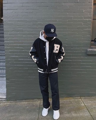 Black Print Varsity Jacket Outfits For Men: This outfit with a black print varsity jacket and black chinos isn't super hard to pull off and is easy to adapt. If you don't know how to round off, a pair of white leather low top sneakers is a wonderful idea.