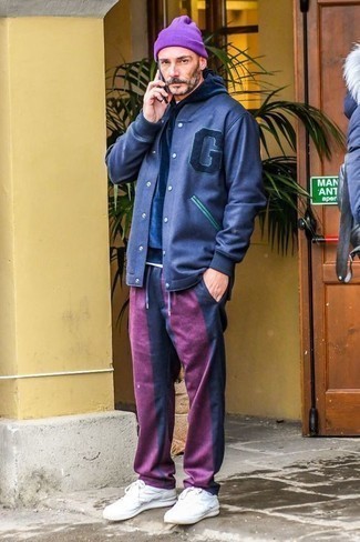 Navy and White Varsity Jacket Outfits For Men: This pairing of a navy and white varsity jacket and purple chinos makes for the ultimate casual style for any modern man. If you're hesitant about how to finish, a pair of white leather low top sneakers is a great option.
