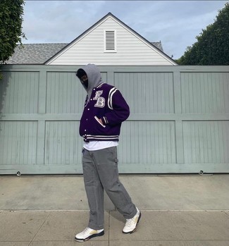 Dark Purple Varsity Jacket Outfits For Men: A dark purple varsity jacket and grey chinos work together harmoniously. If in doubt about the footwear, complete your look with white leather low top sneakers.