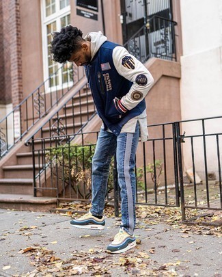 Navy Print Varsity Jacket Outfits For Men: A navy print varsity jacket and blue jeans are both versatile menswear staples that will integrate well within your casual fashion mix. A pair of multi colored athletic shoes instantly amps up the fashion factor of this getup.