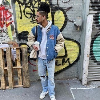 Blue Varsity Jacket Outfits For Men: Want to inject your closet with some casual street style menswear style? Make a blue varsity jacket and light blue ripped jeans your outfit choice. Let your styling prowess truly shine by finishing off this outfit with white athletic shoes.
