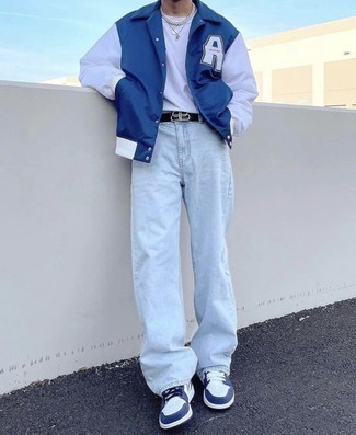 Men's Navy Print Varsity Jacket, White Long Sleeve T-Shirt, Light Blue Jeans, White and Navy Leather Low Top Sneakers