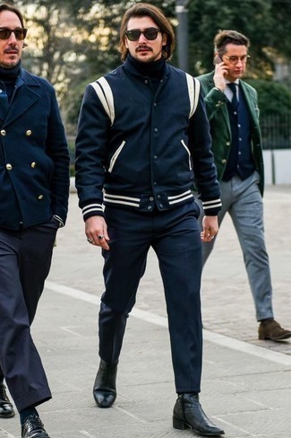 Navy Varsity Jacket Outfits For Men: This combination of a navy varsity jacket and navy chinos speaks laid-back cool and effortless menswear style. Why not take a more polished approach with footwear and add a pair of black leather chelsea boots to the mix?