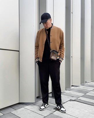 Brown Varsity Jacket Outfits For Men: When the setting permits a laid-back look, try pairing a brown varsity jacket with black chinos. White and black leather low top sneakers are a stylish companion for your getup.