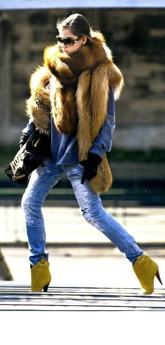 Blue Jeans Outfits For Women: A brown fur vest and blue jeans worn together are a total eye candy for those dressers who prefer ultra-cool looks. Let your outfit coordination sensibilities really shine by rounding off this look with a pair of mustard suede ankle boots.