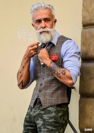 Alessandro Manfredini wearing Brown Plaid Waistcoat, Light Blue Dress Shirt, Olive Camouflage Chinos, Red Lapel Pin