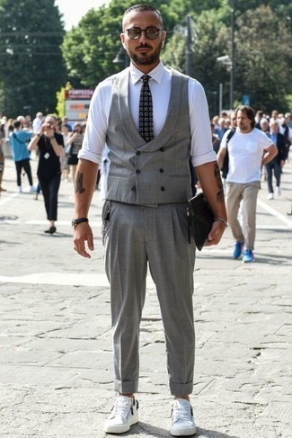 Grey Waistcoat Outfits: Try teaming a grey waistcoat with grey dress pants to be the definition of elegant men's fashion. For something more on the daring side to complement your look, complete this look with a pair of white canvas low top sneakers.