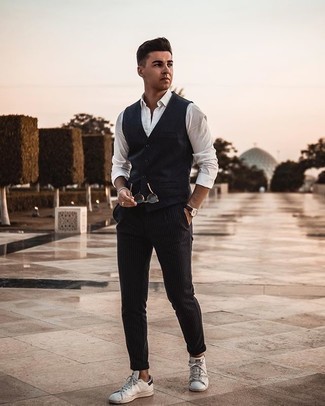 Navy Waistcoat Outfits: Dial up your sprezzatura game in a navy waistcoat and black vertical striped chinos. And if you need to instantly tone down this look with footwear, why not complement this outfit with a pair of white and black leather low top sneakers?