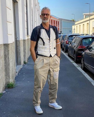 Blue Canvas Backpack Outfits For Men: Marrying a white waistcoat with a blue canvas backpack is a smart choice for a neat and relaxed ensemble. To give this look a more relaxed touch, introduce a pair of white canvas high top sneakers to this ensemble.