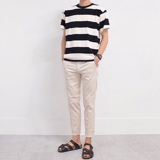 Black Watch Outfits For Men: We're all seeking practicality when it comes to style, and this off-duty combo of a white and black horizontal striped crew-neck t-shirt and a black watch is a great illustration of that. To give your outfit a more casual aesthetic, complement this outfit with dark brown leather sandals.