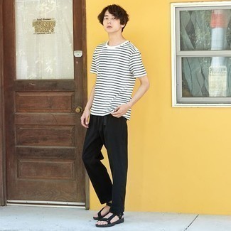 Black Chinos Hot Weather Outfits: This combo of a white and black horizontal striped crew-neck t-shirt and black chinos makes for the ultimate casual style for today's gentleman. Add a pair of black canvas sandals to your ensemble to immediately kick up the street cred of your ensemble.