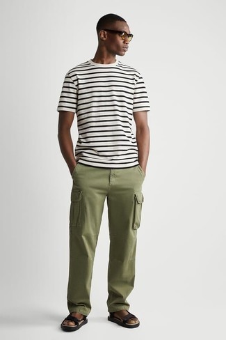 Black Canvas Sandals Outfits For Men: This combo of a white and black horizontal striped crew-neck t-shirt and olive cargo pants is extremely easy to do and so comfortable to work all day long as well! If you wish to instantly tone down this ensemble with one piece, complete your outfit with black canvas sandals.