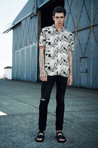 Black Leather Sandals Outfits For Men: If you're on the lookout for an edgy yet seriously stylish ensemble, consider wearing a white and black floral short sleeve shirt and black ripped jeans. A pair of black leather sandals will instantly dress down an all-too-polished outfit.