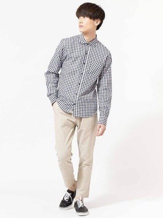 White and Black Gingham Long Sleeve Shirt Outfits For Men: This pairing of a white and black gingham long sleeve shirt and beige chinos will prove your prowess in men's fashion even on off-duty days. A pair of black and white canvas low top sneakers is a winning footwear style that's full of character.