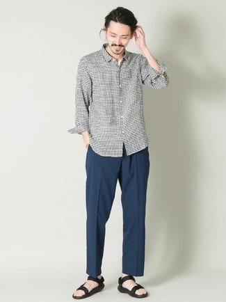 White Gingham Long Sleeve Shirt Outfits For Men: A white gingham long sleeve shirt and navy chinos are the kind of a foolproof casual combination that you need when you have zero time. To give your overall getup a more relaxed feel, add black canvas sandals to the equation.