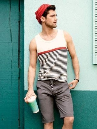 Burgundy Beanie Outfits For Men: Show your easy-going side by wearing a white and black horizontal striped tank and a burgundy beanie.