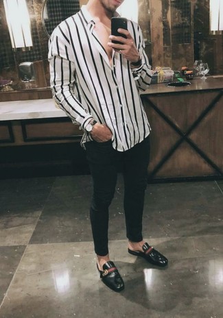 White and Black Vertical Striped Long Sleeve Shirt Outfits For Men: If you like casual combinations, then you'll like this combination of a white and black vertical striped long sleeve shirt and black skinny jeans. Black leather low top sneakers are a guaranteed way to give an added dose of class to your look.