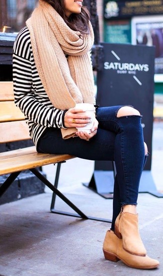 Beige Leather Ankle Boots Outfits: A white and black horizontal striped long sleeve t-shirt and navy ripped skinny jeans are a wonderful pairing to keep in your casual styling rotation. If you feel like stepping it up a bit now, add a pair of beige leather ankle boots to this getup.