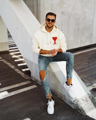 Men's Black Sunglasses, White and Black Leather Low Top Sneakers, Blue Ripped Skinny Jeans, White Print Hoodie