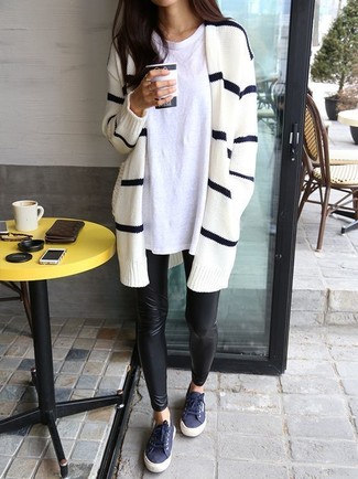 Blue Low Top Sneakers Outfits For Women: A white and black horizontal striped open cardigan and black leather leggings worn together are such a dreamy getup for those who prefer cool chic styles. A pair of blue low top sneakers will pull this full look together.