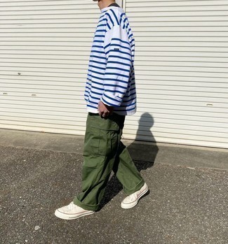 Olive Cargo Pants Outfits: If you're in search of an edgy but also sharp look, pair a white and blue horizontal striped long sleeve t-shirt with olive cargo pants. Rounding off with a pair of white canvas low top sneakers is a guaranteed way to introduce some extra fanciness to this outfit.