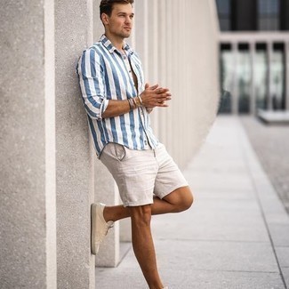 Tan Shorts Outfits For Men: This casual combo of a white and blue vertical striped short sleeve shirt and tan shorts comes in handy when you need to look stylish but have no time. If you're hesitant about how to finish off, introduce beige canvas low top sneakers to the mix.