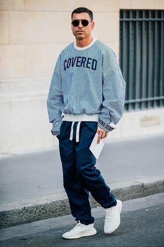 Navy Cargo Pants Outfits: This combination of a white and blue sweatshirt and navy cargo pants is impeccably stylish and yet it's easy enough and apt for anything. You know how to bring a more laid-back twist to this look: white athletic shoes.